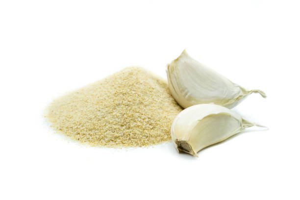 Pile of garlic powder isolated on white background