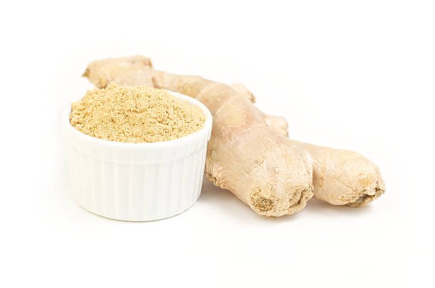 Ginger , root and ground ginger in white dish isolated on white background