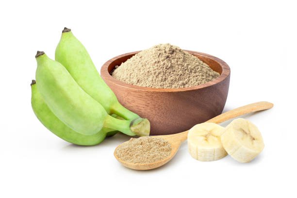 Banana flour (banana protein powder) in wooden bowl and spoon with fresh fruit isolated on white background.